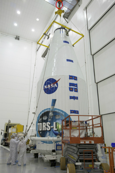 A crane lifts a capsule at NASA